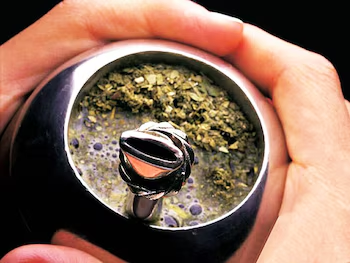 Argentine mate with leaf and stem yerba, served in a traditional gourd with a metal bombilla