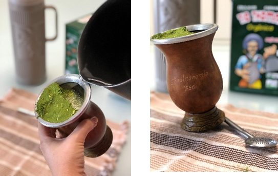 Preparing Brazilian chimarrão in a traditional cuia, showing fine green yerba mate and pouring hot water